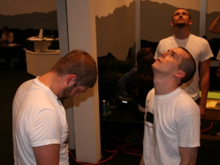 Documentation of a performance featuring a team of &ldquo;coal miners&rdquo; and a team of &ldquo;astronomers,&rdquo; in which members of opposing teams wrestle with their eyes physically pressed against each other