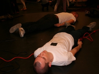 Documentation of a performance featuring a team of &ldquo;coal miners&rdquo; and a team of &ldquo;astronomers,&rdquo; in which members of opposing teams wrestle with their eyes physically pressed against each other