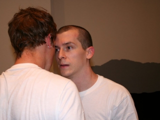 Documentation of a performance featuring a team of &ldquo;coal miners&rdquo; and a team of &ldquo;astronomers,&rdquo; in which members of opposing teams wrestle with their eyes physically pressed against each other